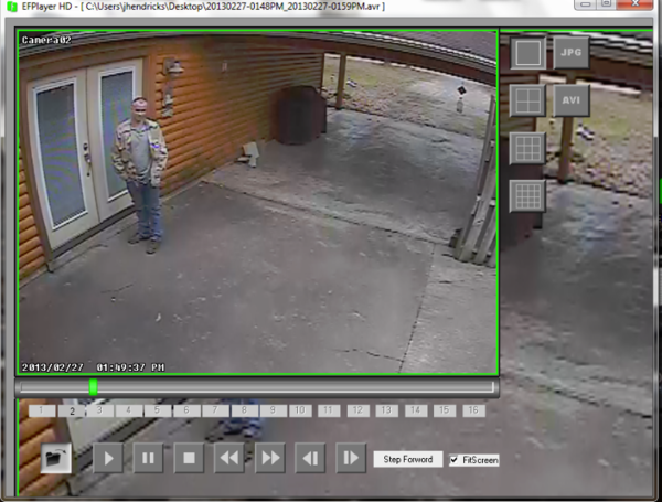 Security footage of a man standing at a door facing the camera.