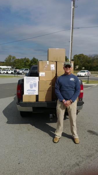 Sheriff Marty Moss standing in front of boxes of the prescription drugs that were collected during the Drug Take Back Event.