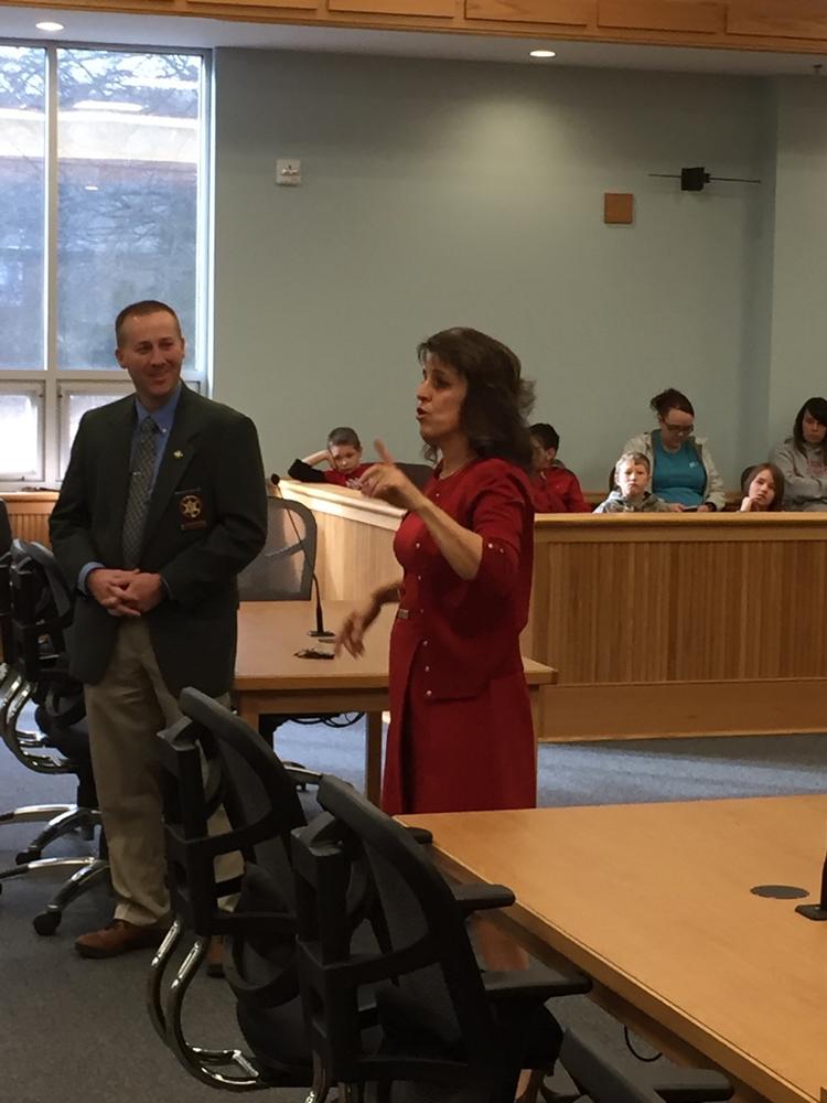 Sheriff Chris Brown listening as a woman discusses a branch of the government with the students.