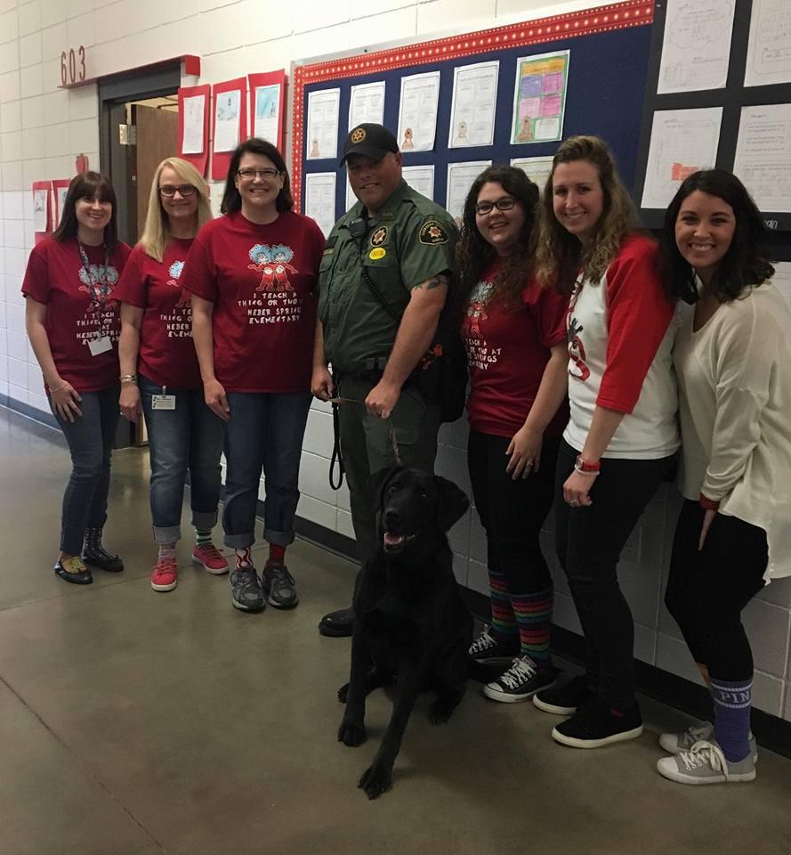 Heber Springs Elementary School staff pose with Deputy McLain and K9 Zeke.