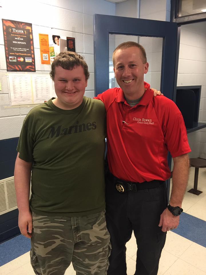 Sheriff Brown standing with a student.