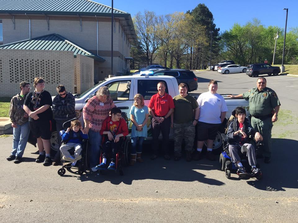 Group pose in front of the Cleburne County Sheriff's truck.