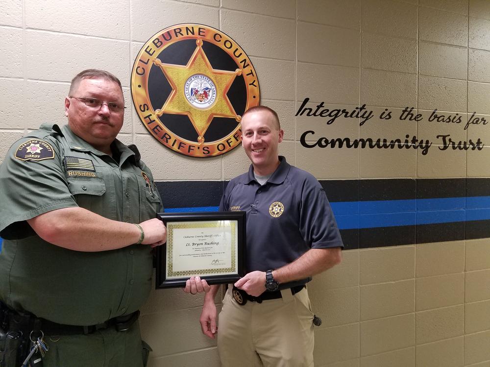 Lieutenant Byron Rushing receiving award for Deputy of the Quarter from Sheriff Chris Brown.