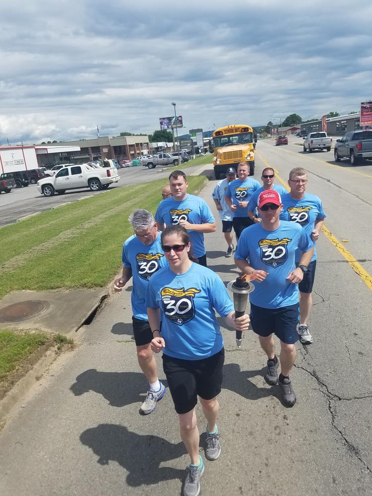 Lady leading the Law Enforcement Torch Run.