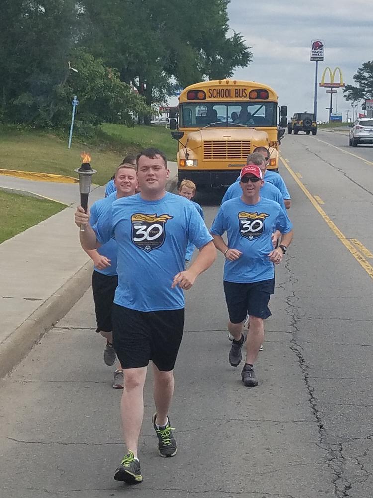 Another member of the group leading the run with torch in hand. 