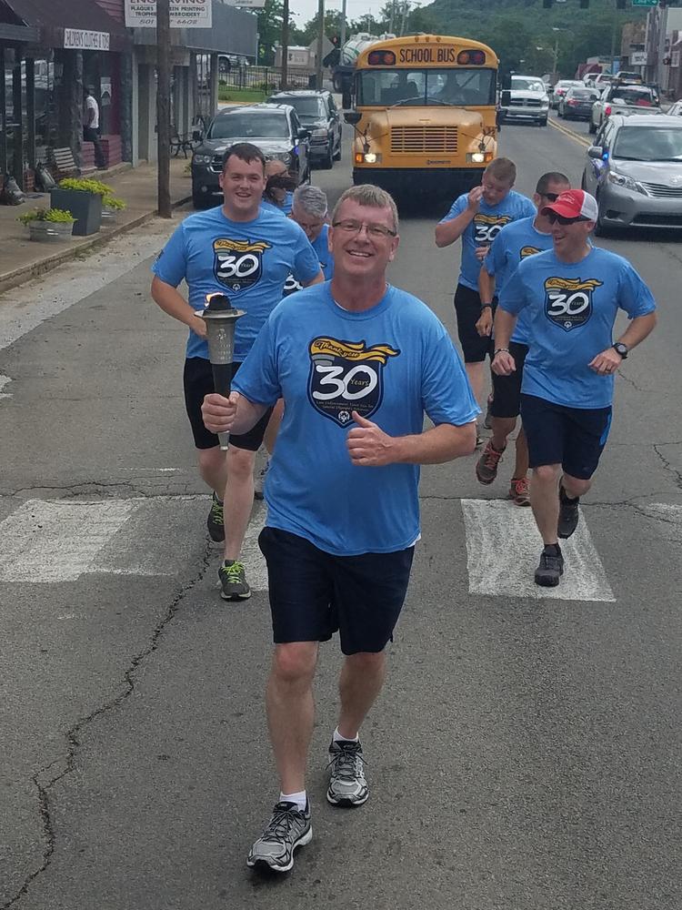 Another gentleman leading the team through town during the torch run.