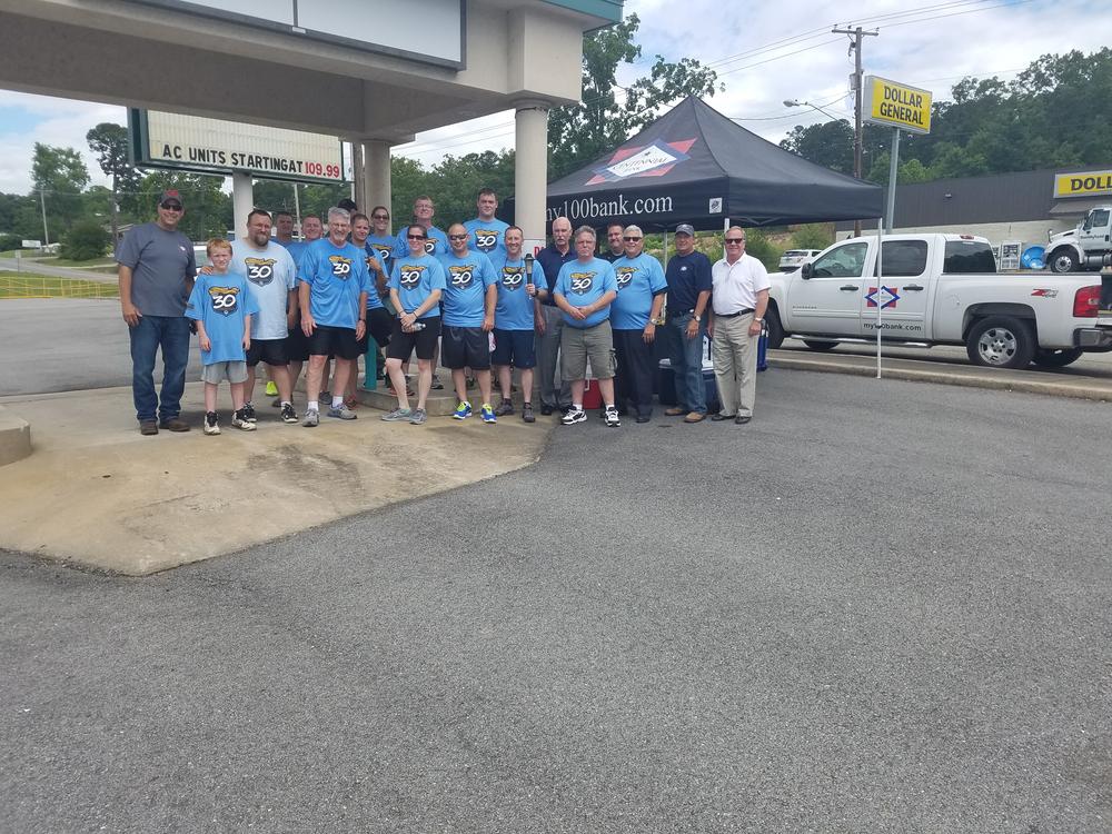 The entire group standing together outside to commemorate the first Cleburne County Torch Run leg as part of the Law Enforcement Torch Run for Special Olympics.