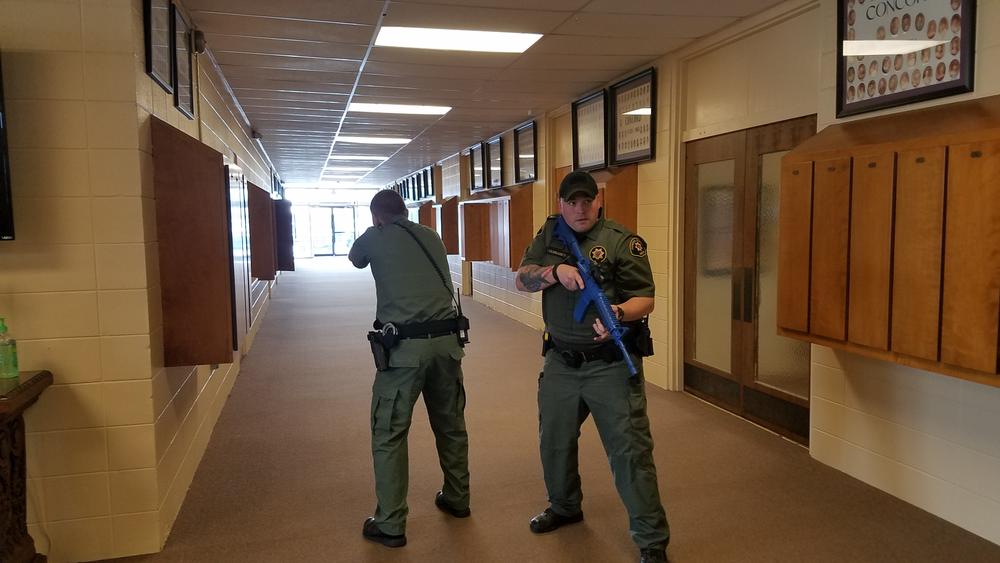 Two deputies standing ready during active shooter drill.
