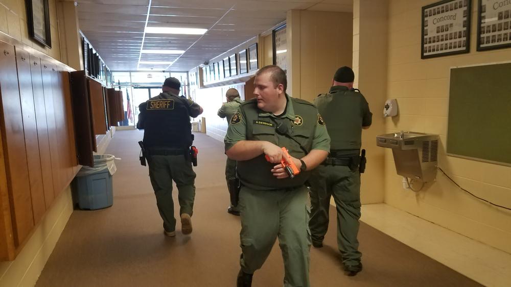Four deputies guarding each other during active shooter drill.