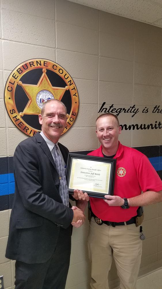 Detective Jeff Bittle receiving Deputy of the Quarter award from Sheriff Chris Brown.