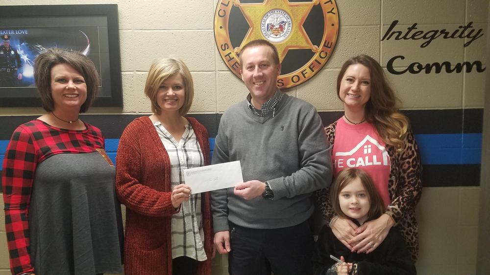 Sheriff Chris Brown giving fundraiser proceeds to The Call.