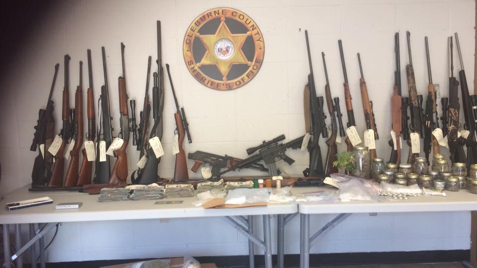 Guns, drugs, and money seized.