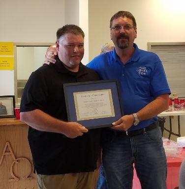 Deputy Jeff McLain receiving certificate of appreciation from The Other Side member.