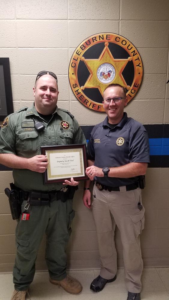 Deputy Jacob Teel receiving Deputy of the Quarter award from Sheriff Chris Brown.