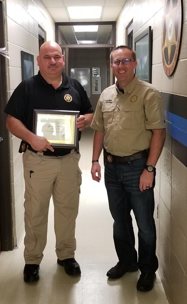 Tony McHan receiving award from Sheriff Brown.