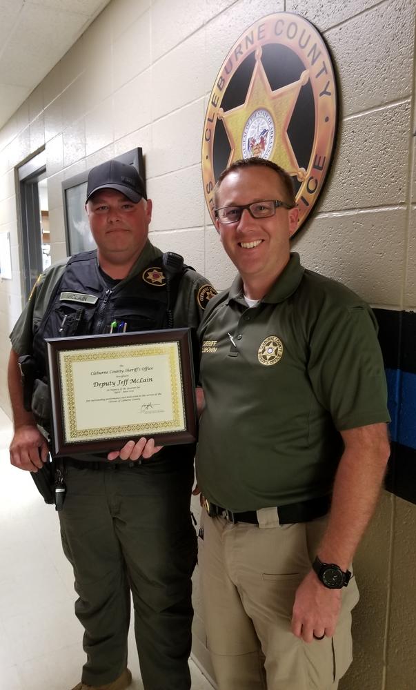 Deputy McLain receiving award from Sheriff Chris Brown.