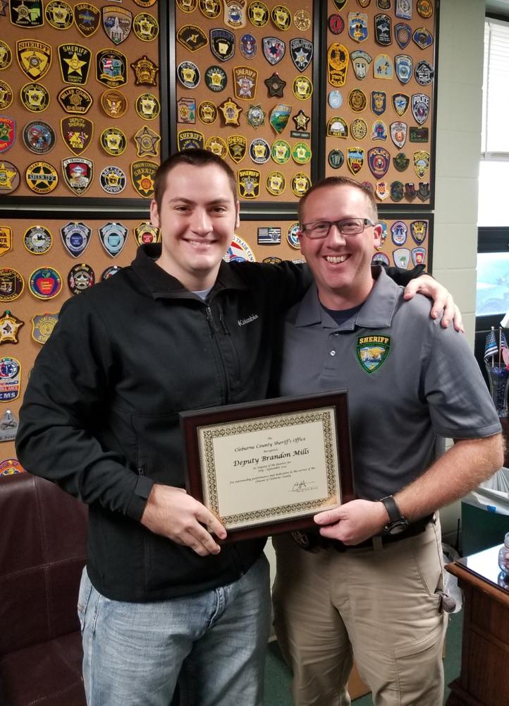 Deputy Mills receiving award from Sheriff Brown.