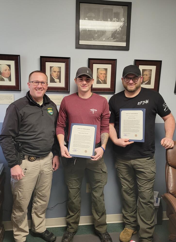 Sheriff Brown awarding Deputy Cresswell and Deputy Milam their letters of commendation.