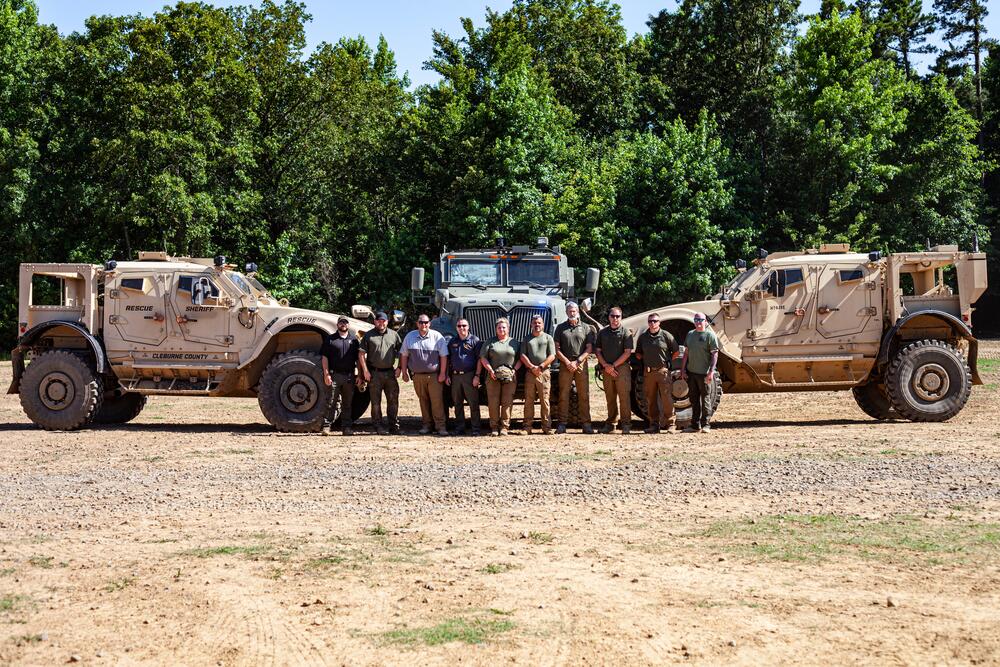 Group posing in front of the ARVs.