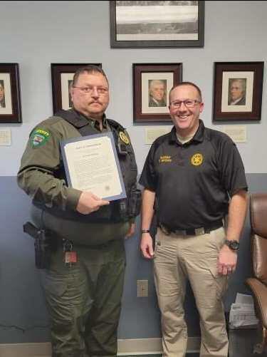 Lt Rushing receiving award from Sheriff Brown.